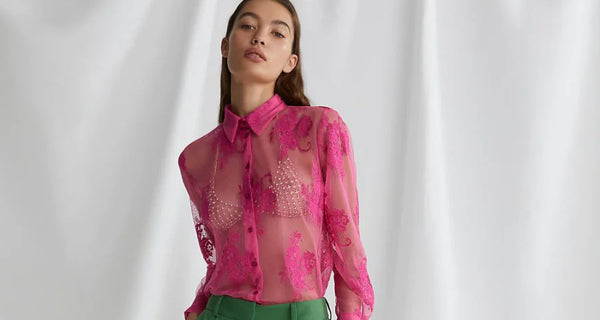 model wears a pink blouse by Dixie